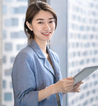 woman smiling while holding a tablet